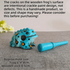 Handmade wooden frog percussion instrument with intentional crackle paint design and a wooden stick.