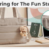 A beige boxy tote bag is shown next to a laptop and stationery, demonstrating the D-ring feature for fun stuff.