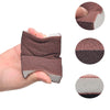 A hand holds a heavy-duty emery sponge for pots and pans, showing its texture and different shades.