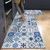 A rectangular blue and white patterned non-slip absorbent floor mat placed on a light wood floor.