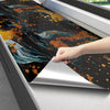 A hand is peeling off a sheet of self-adhesive marble contact paper featuring an abstract dark blue and gold marbled design.