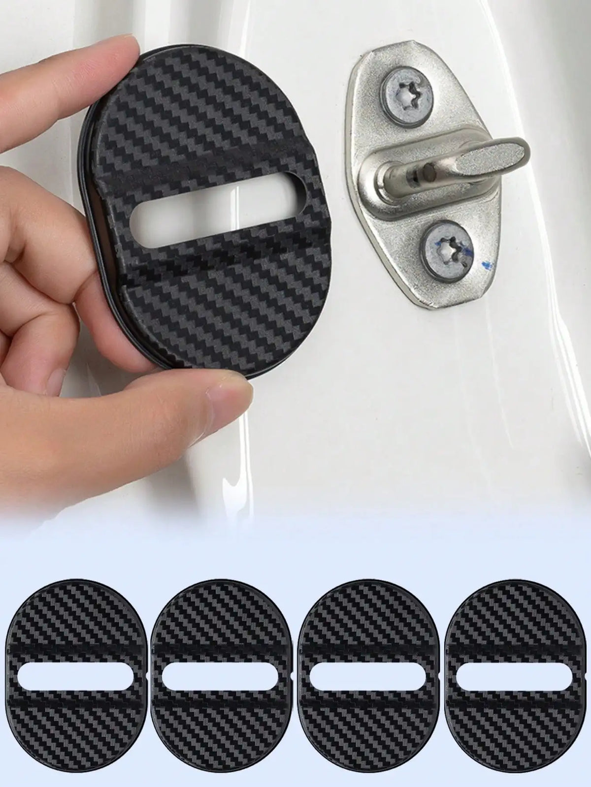 A hand holds a black carbon-fiber door lock cover next to a silver door lock mechanism.