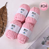 Pink Milk Cotton yarn skeins in various sizes displayed on a white surface.