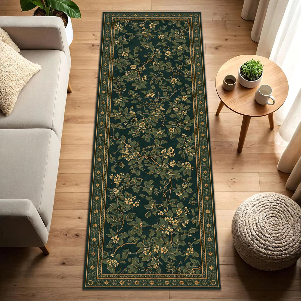 A long, dark green botanical runner rug with gold accents laid on a light wood floor.