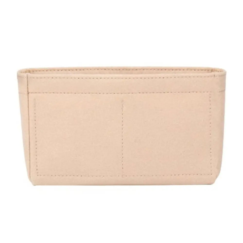 A light beige soft felt handbag organizer insert with multiple pockets.