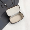 A vintage woven PU leather crossbody bag with a brown strap is shown open on a white surface.