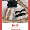 A close-up of a gold-framed display showing black and white ruffled fabric chains for a bohemian starfish and pearl bag acces