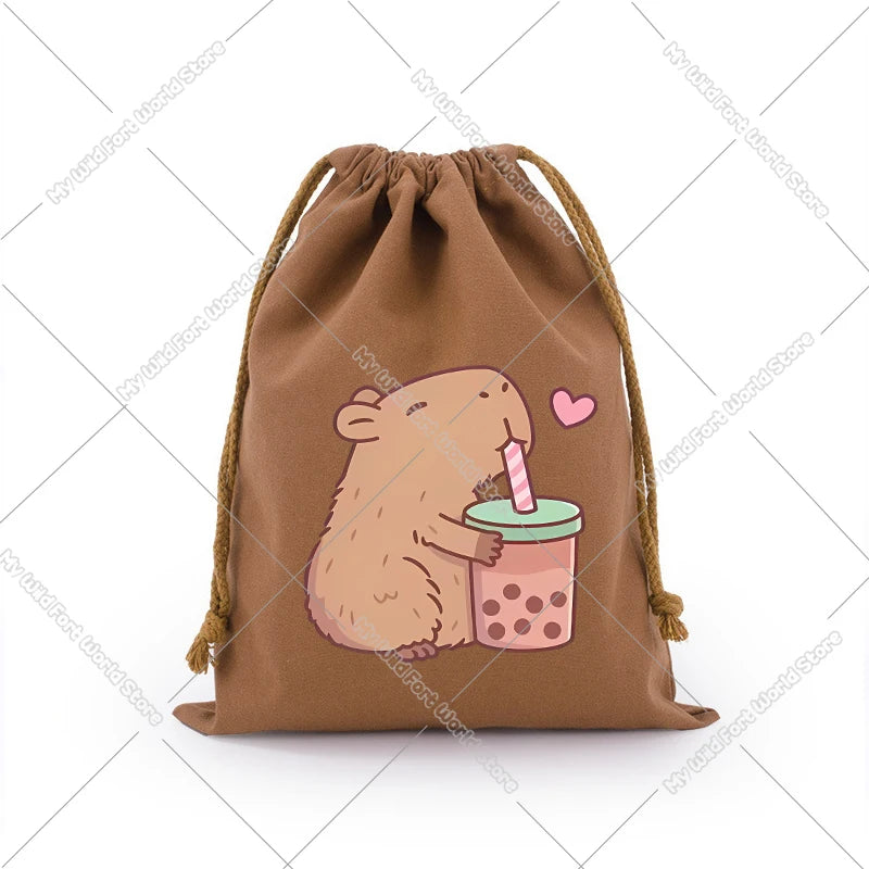 A brown drawstring storage bag featuring a cute capybara illustration holding a pink lollipop.