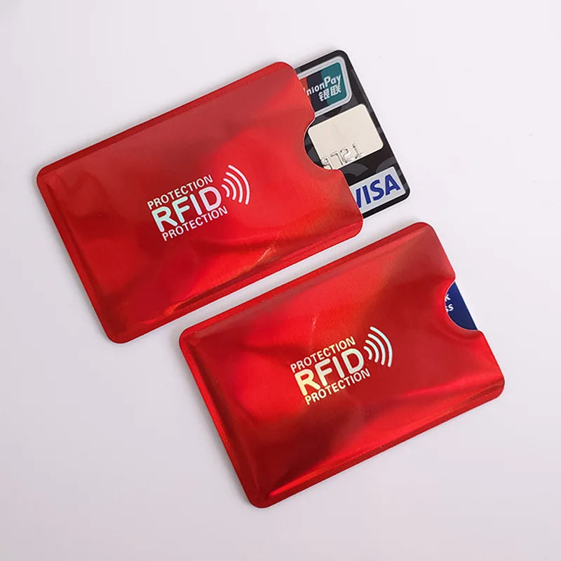 A set of red RFID protection card sleeves and a black credit card are shown on a white background.