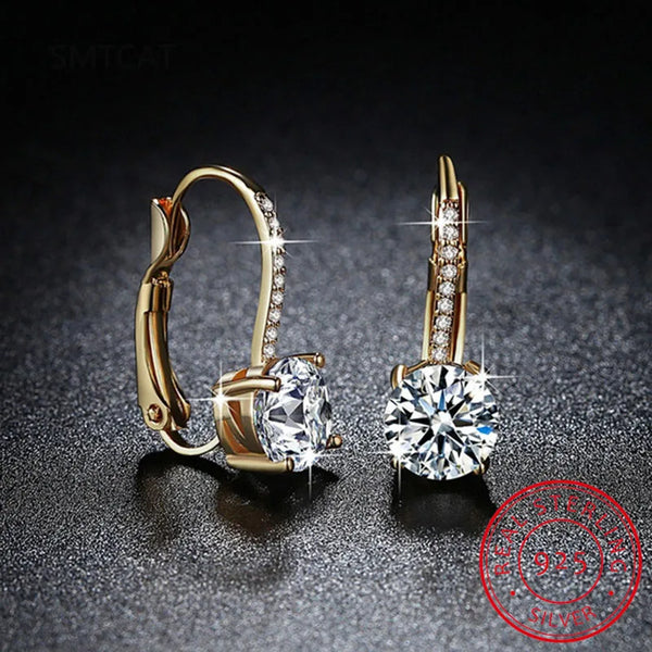Pair of 14K gold plated moissanite drop earrings with brilliant clear stones.