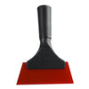 A black car window squeegee with a soft rubber blade resting on a red surface.