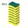 Eight green and yellow double-sided cleaning sponges stacked vertically