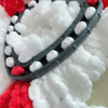 A close-up of a black and white microfiber mop pad replacement with red yarn accents.