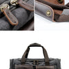 A dark gray canvas duffel bag featuring brown leather straps and pockets.