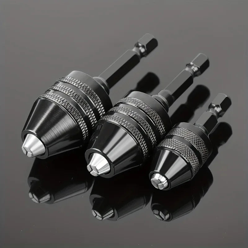 A close-up view of a black quick-change hex shank drill chuck with a round handle resting on a dark, reflective surface.