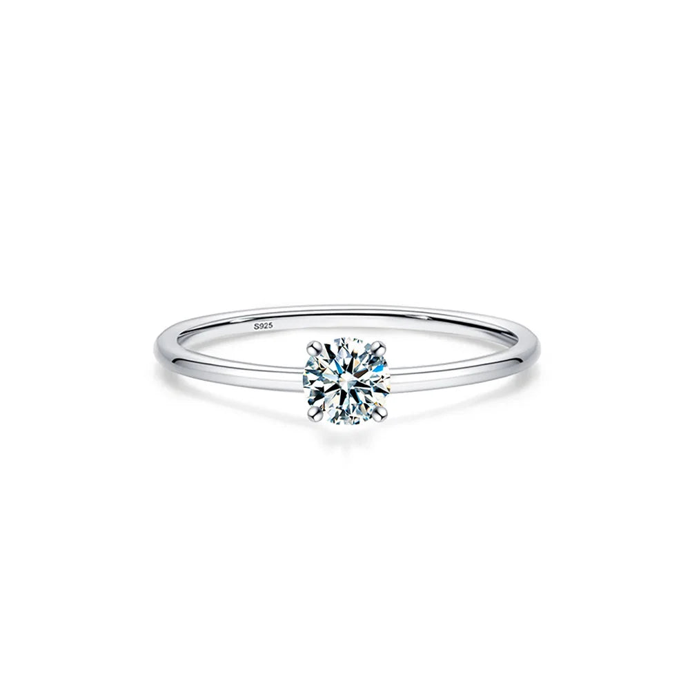 A minimalist moissanite solitaire ring set in sterling silver with a round brilliant-cut stone.