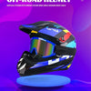 A black and blue off-road helmet with a reflective visor displayed on a round blue stand.