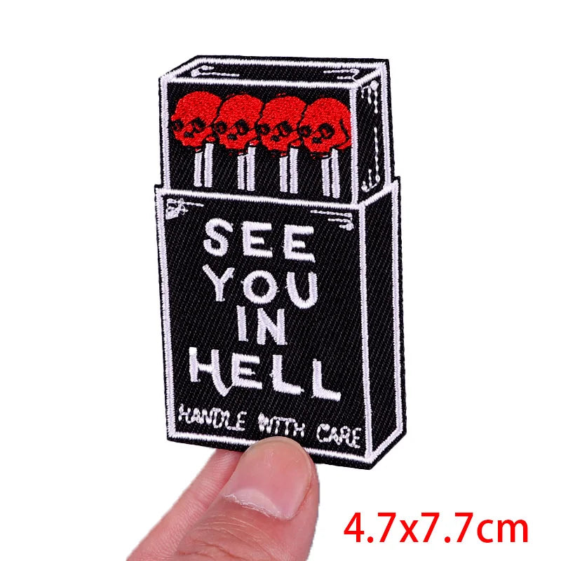 Black iron-on letter patches featuring a skull design and the text SEE YOU IN HELL on a rectangular background
