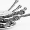 Close-up of steel wire trimmer brush heads with fine, twisted wires against a white background.