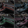 Interior view of a car dashboard showing various neon accent light strips in red, blue, and pink colors.