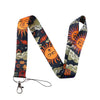 A patterned lanyard featuring celestial sun and moon designs on dark fabric.