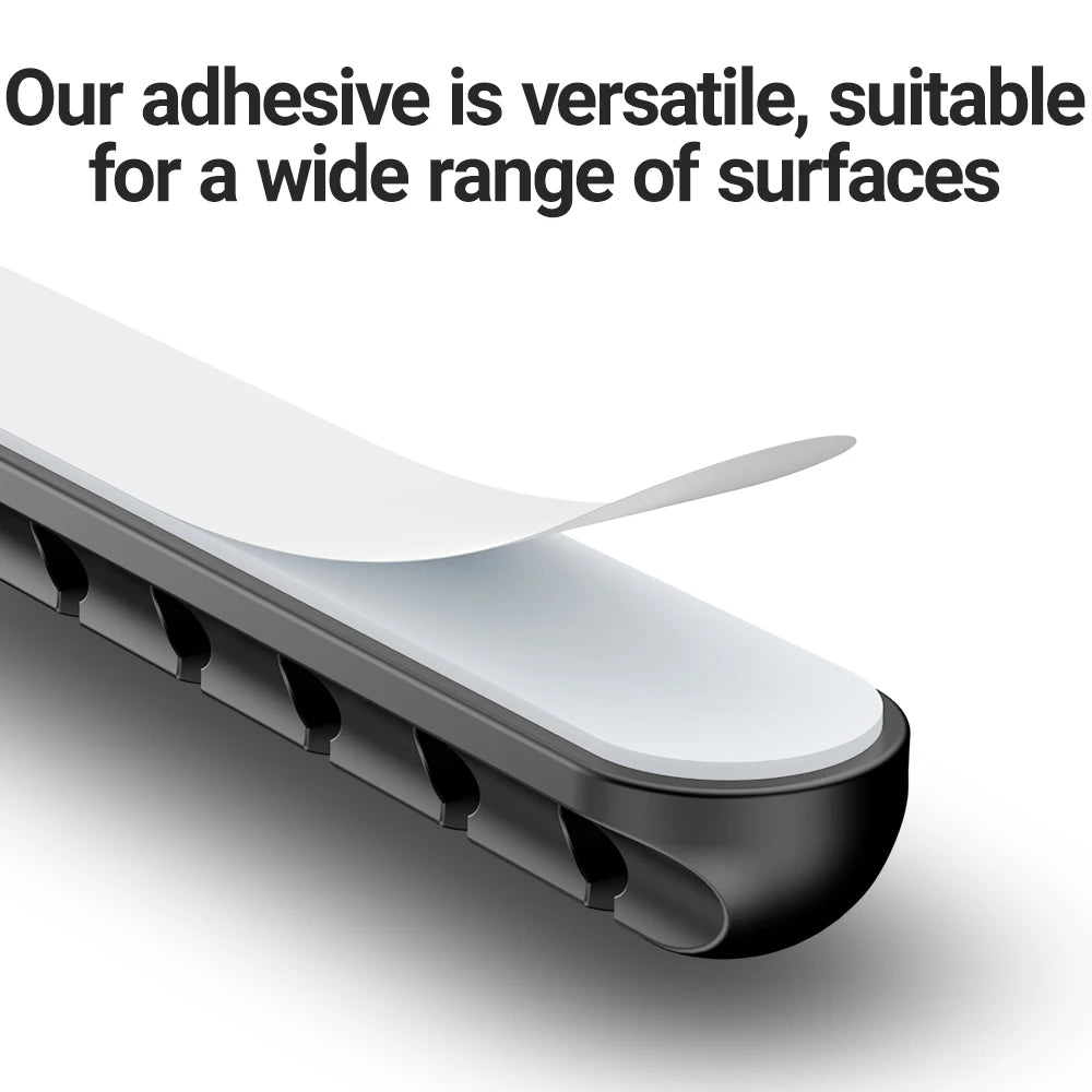 A close-up view of a black adhesive cable management clip with a white strip, demonstrating its versatility.