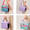 A collection of colorful insulated lunch bags in various patterns and colors being held by a person.