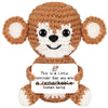 A handmade crochet brown animal doll with large ears and a white card that reads This is a little reminder that you are a rem