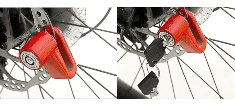 Close-up of a red anti-theft disc brake lock attached to a bicycle wheel.