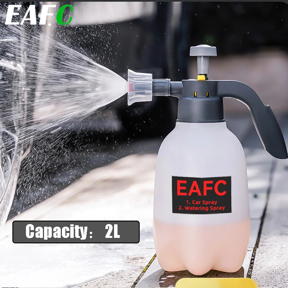 A white 2L hand pump foam sprayer is shown spraying water onto a surface.