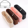 Set of three felt bag organizers in beige, brown, and pink with zippered pockets