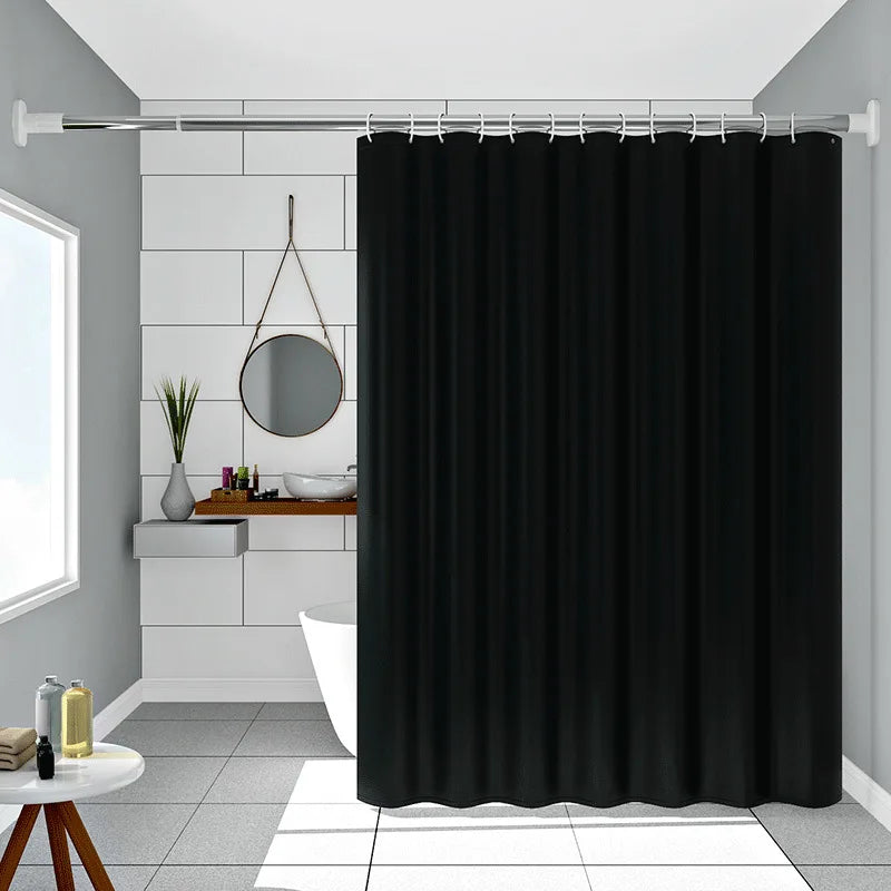 Solid black waterproof PEVA shower curtain hanging on a rod in a bathroom