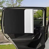 Black and white magnetic sun shades installed in a car window for UV protection and glare reduction