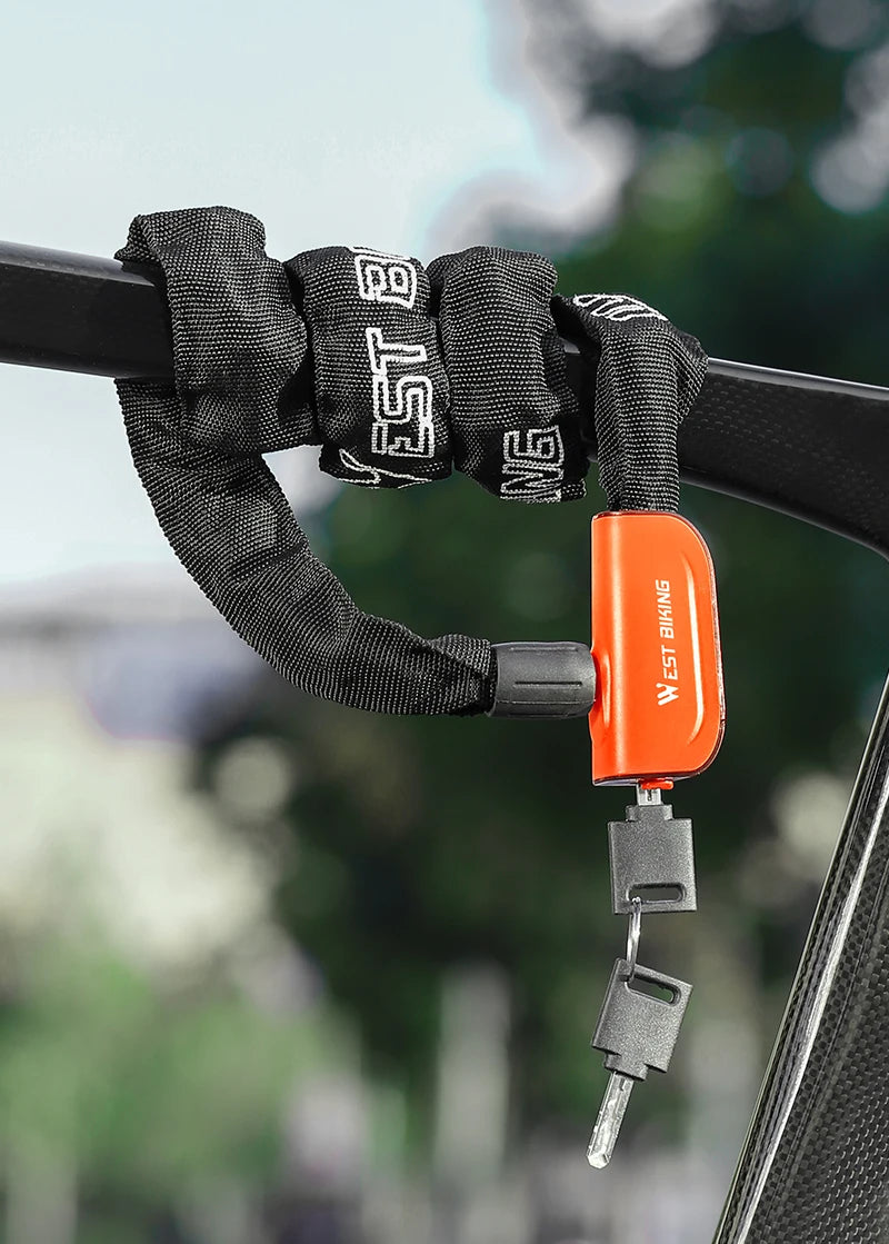 An orange heavy-duty chain lock for bikes with two keys is shown attached to a black bicycle frame.