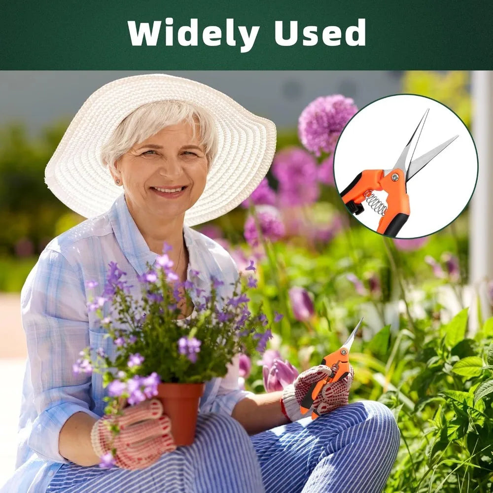 An elderly woman wearing a straw hat is using orange garden scissors to prune plants.