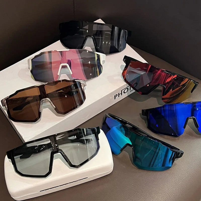 A collection of various colored sunglasses, including black, pink, brown, and blue, displayed on a white surface.