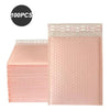 A stack of 100 pink bubble mailers, padded self-seal shipping envelopes.