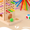 A wooden pick-up sticks board game featuring colorful sticks and a small marble on a light wood surface.