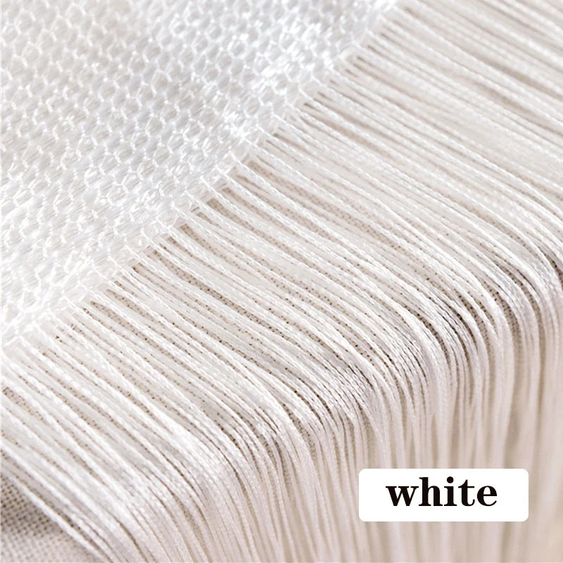 Close-up of white beaded thread curtain fabric showing fine threads and texture.