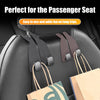 Black headrest hooks used to organize bags and items on a car passenger seat.