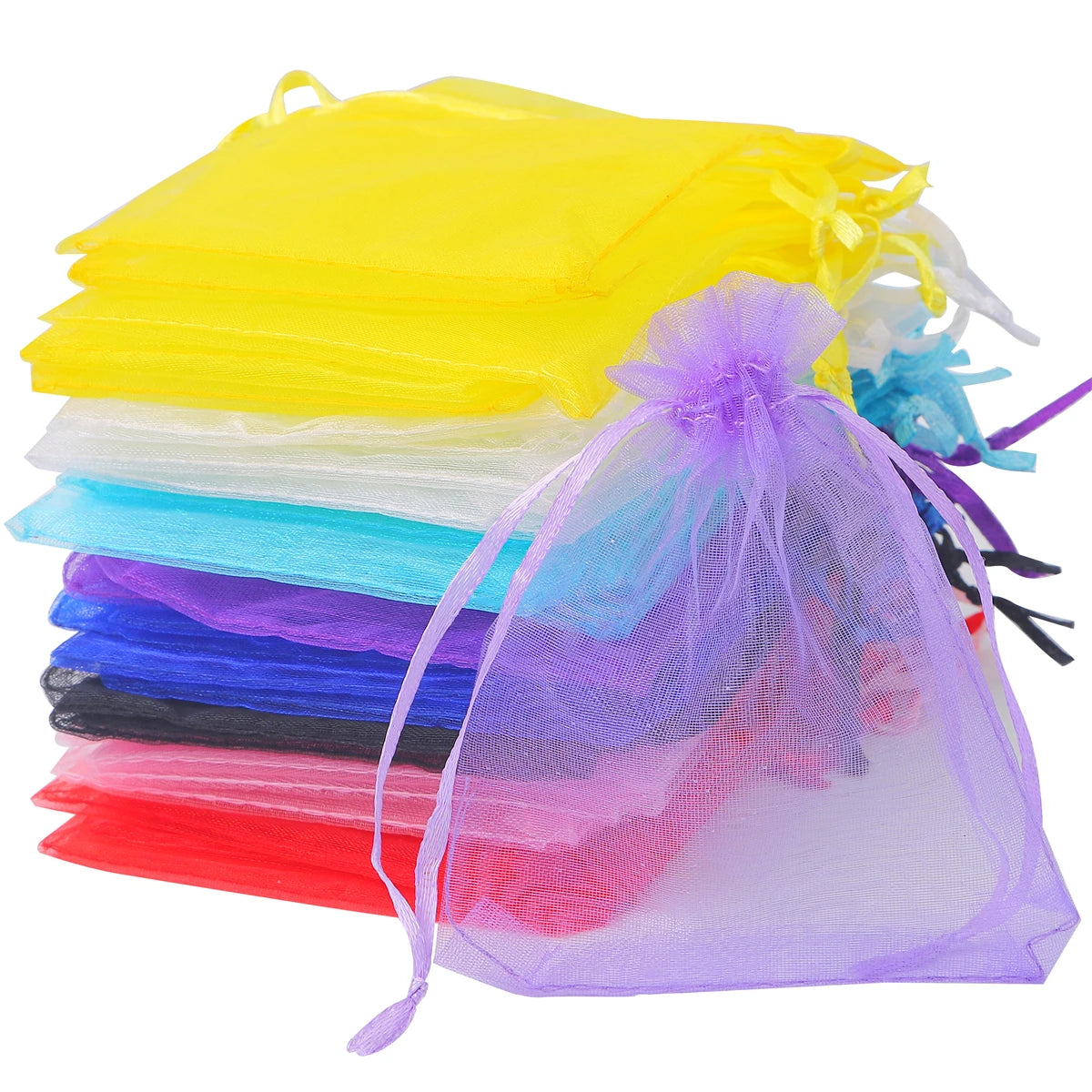 A stack of assorted organza drawstring gift bags in various colors including yellow, white, blue, purple, and pink.