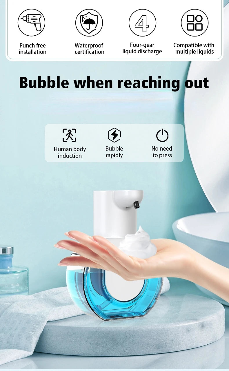 A hand is dispensing foam soap from a blue wall-mounted infrared automatic dispenser onto a toilet bowl.