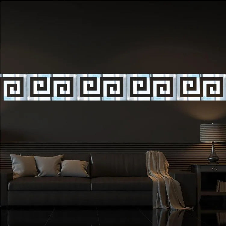 A horizontal acrylic mirror wall sticker featuring a geometric maze pattern mounted on a dark wall above a sofa.