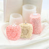 Pink rose pillar candles in various sizes and a large book with candle molds
