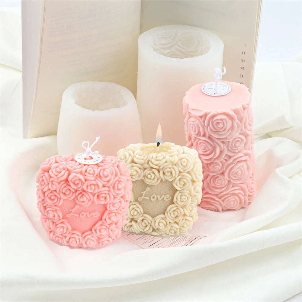 Pink rose pillar candles in various sizes and a large book with candle molds