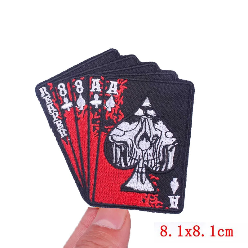 Black embroidered patch featuring a rose skull design with an iron-on backing