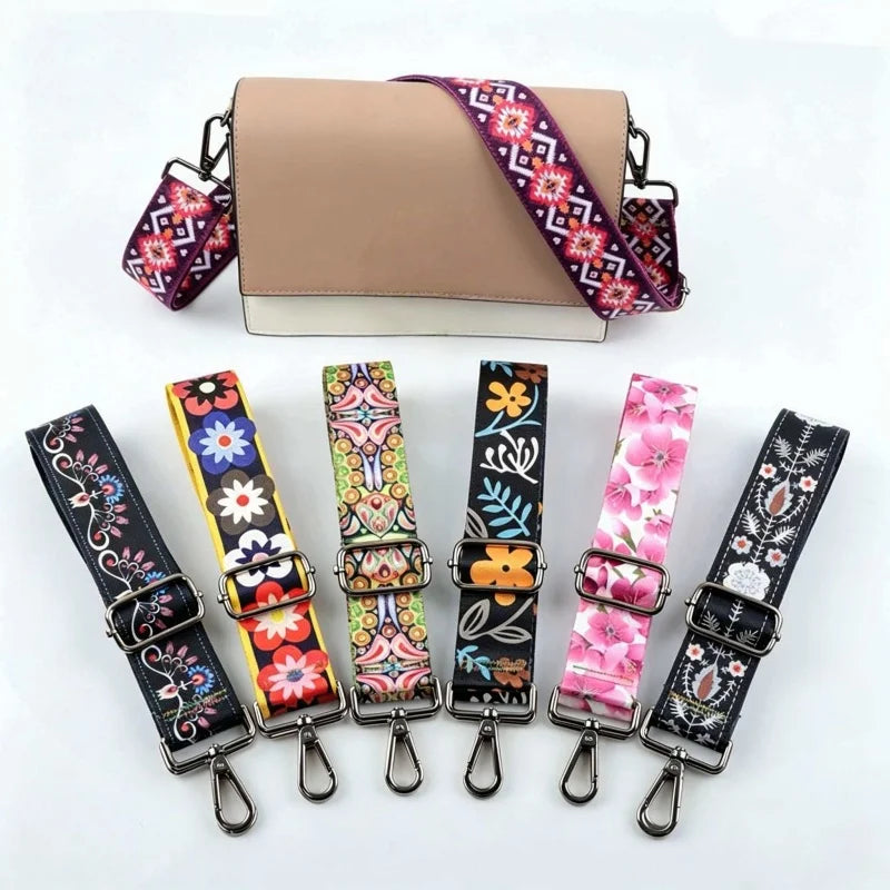 A beige crossbody bag with a purple and pink floral patterned strap is shown alongside several other colorful patterned strap