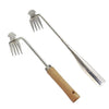 Stainless steel weeding tool with a wooden handle used for garden root removal.
