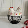 A white ceramic hen-shaped egg basket with a lid displayed on a white surface.