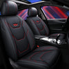 Black leather car seat covers with red stitching installed in a vehicle interior.